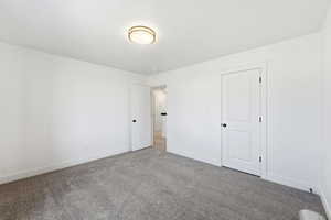 Bedroom with carpet floors and baseboards