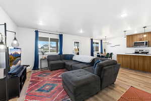 Living room with LVP flooring and a chandelier