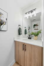 Half Bathroom with vanity and baseboards