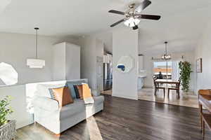 Living room with laminate floors, high vaulted ceiling, and a ceiling fan