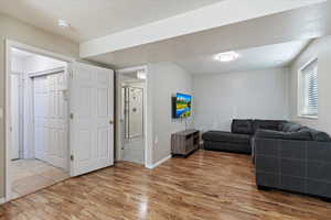 Living area featuring light laminate flooring and baseboards