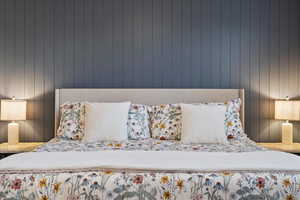 Bedroom featuring wood walls