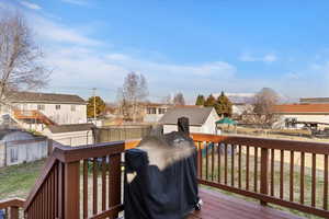 Deck featuring a residential view, a fenced backyard, area for grilling