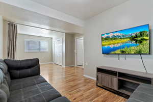 Living area featuring laminate flooring and baseboards