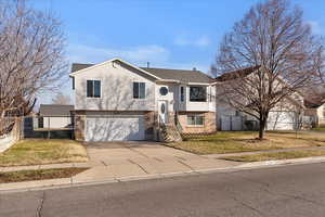Split foyer home with driveway and an attached garage