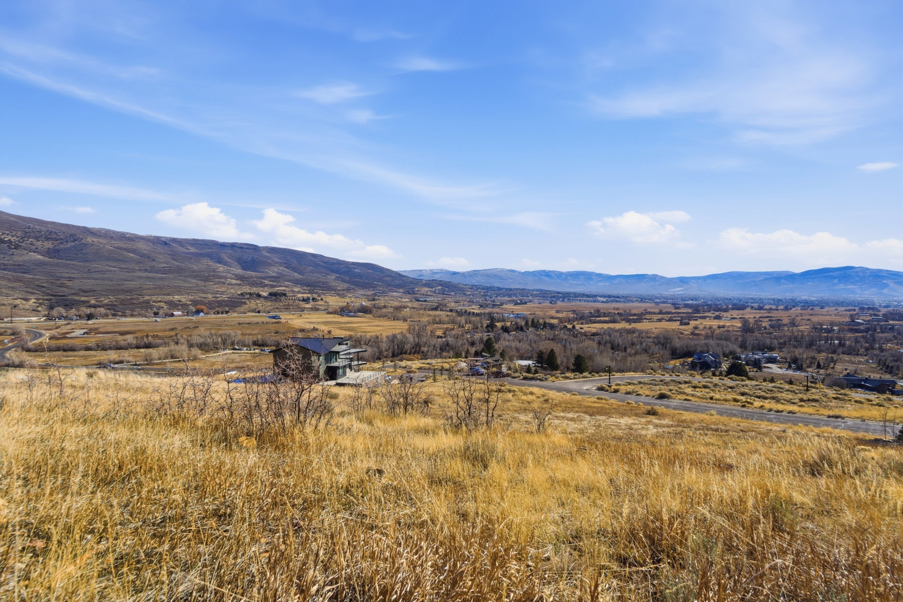 View of mountain backdrop featuring rural landscape