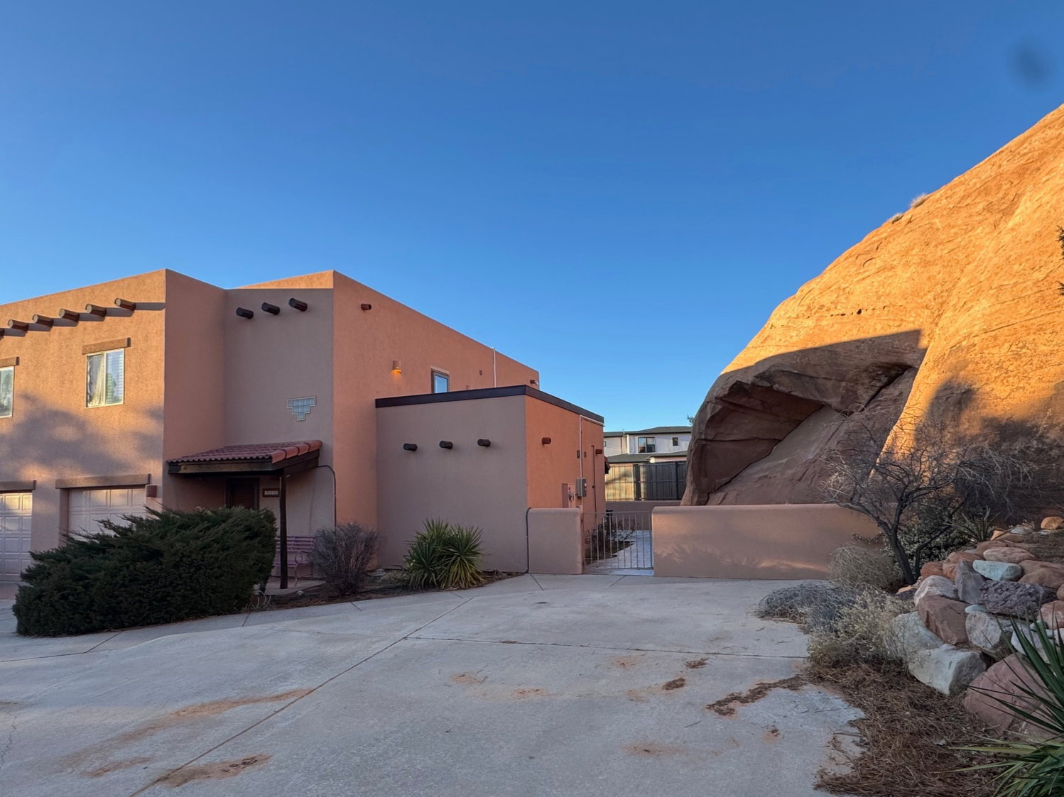 View of property exterior with a gate and stucco siding