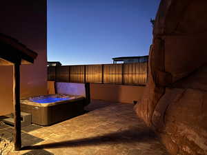 View of patio with a hot tub.  Great privacy.