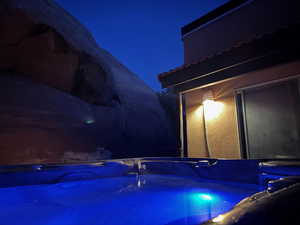 Pool at night with a hot tub.  Easy access from master bedroom