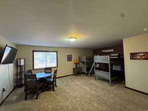 Carpeted dining room featuring baseboards