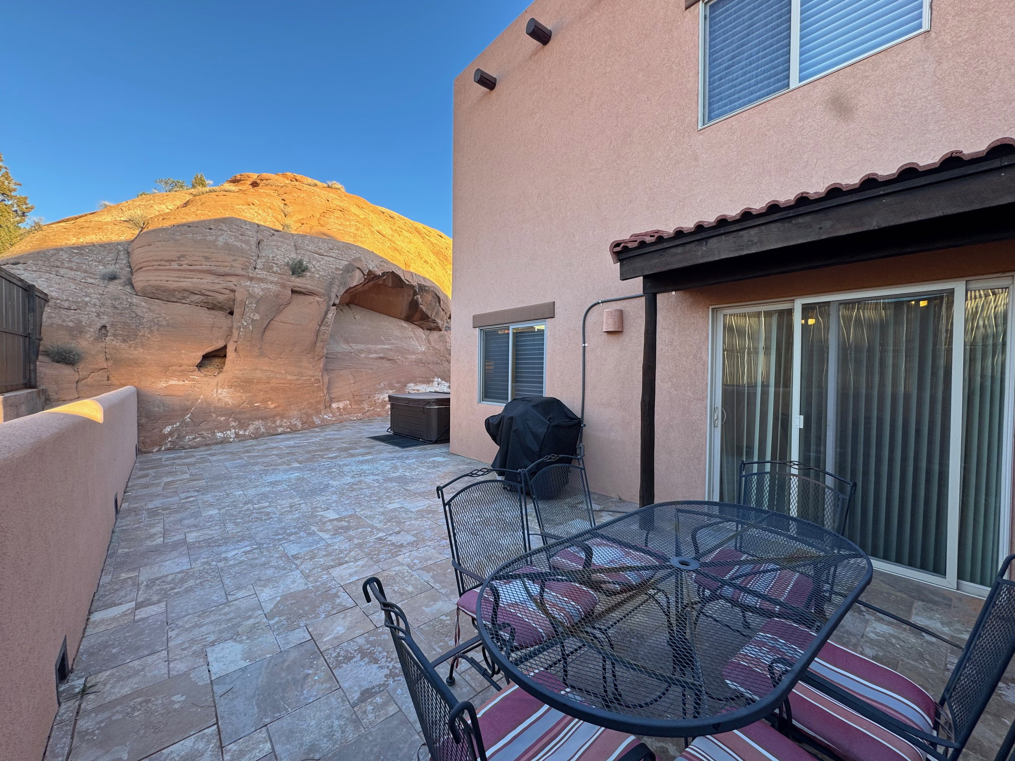 View of patio with outdoor dining space and grill