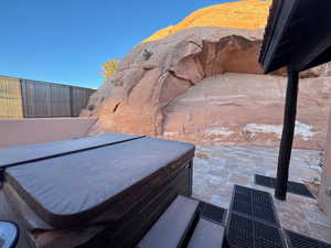 View of patio featuring a large hot tub