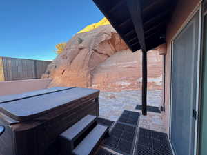View of patio with a hot tub.  Beautiful sandstone setting
