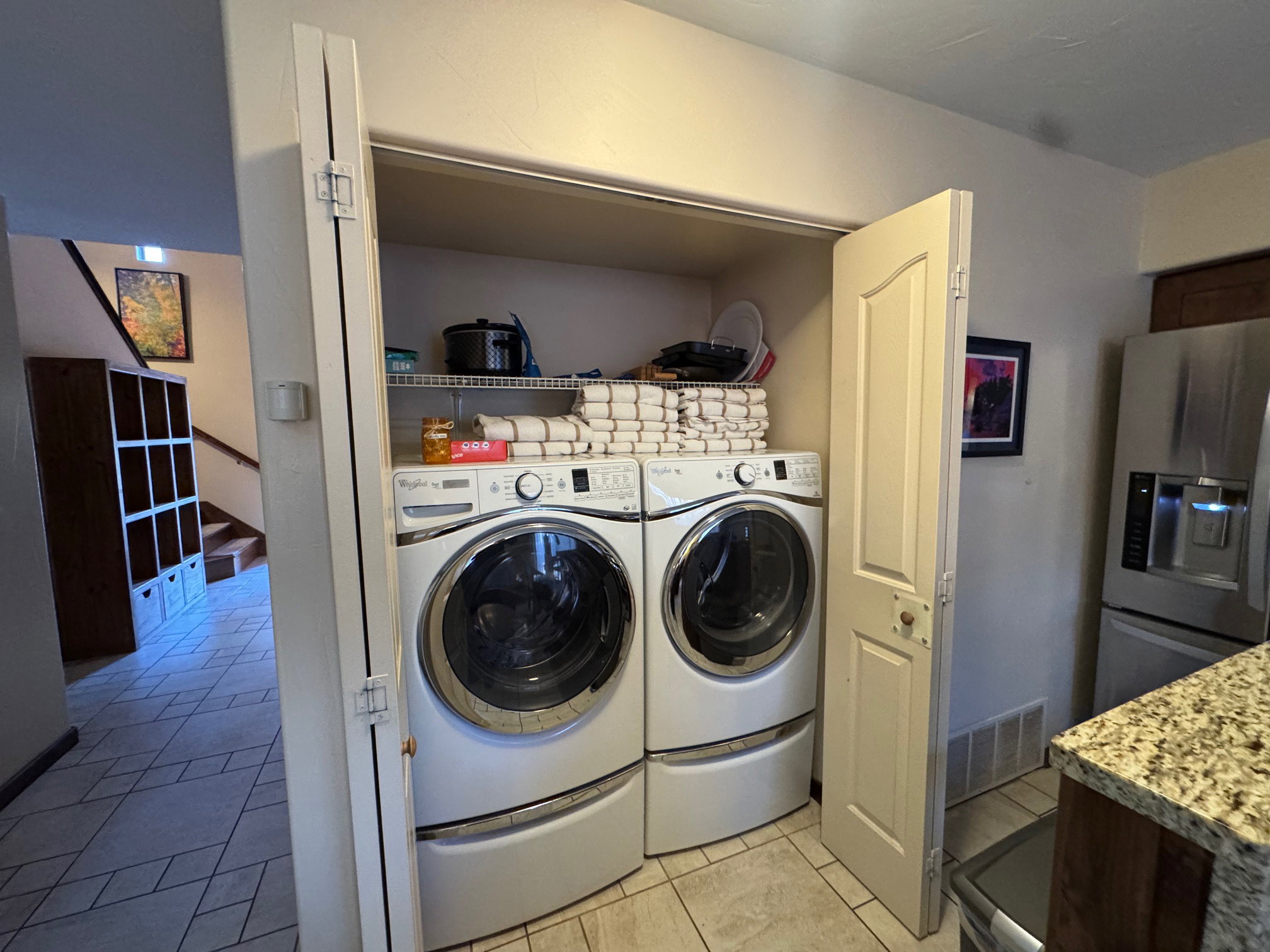 Laundry area featuring washer and dryer and light tile patterned floors