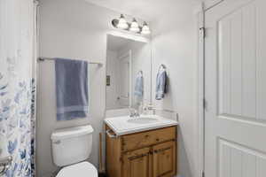 Bathroom with curtained shower and vanity