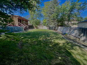 Fenced backyard featuring stairway