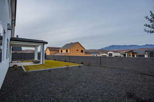 Fenced backyard with a residential view, a patio area, and a mountain view