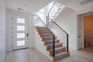 Entryway featuring healthy amount of natural light and stairway