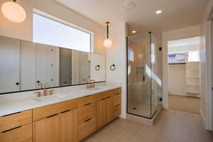 Full bathroom with a stall shower, double vanity, plenty of natural light, light tile patterned flooring, and recessed lighting
