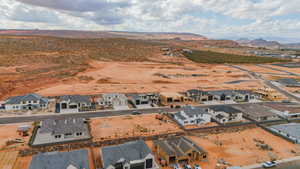 Aerial view of residential area with a mountain backdrop and a desert landscape