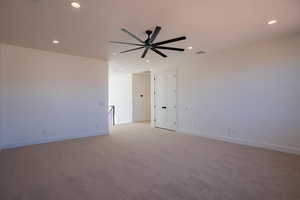 Spare room with light carpet, recessed lighting, and a ceiling fan
