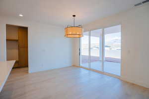 Unfurnished dining area with recessed lighting and a mountain view