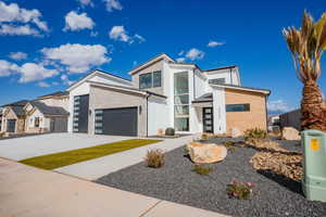 Modern home with concrete driveway and brick siding