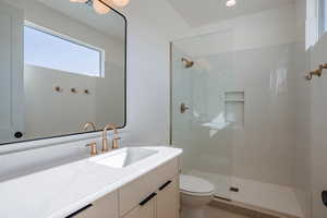 Bathroom featuring vanity, a walk in shower, and light tile patterned floors
