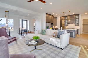 Living area featuring light wood-type flooring, recessed lighting, and a ceiling fan