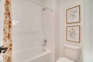 Full bath featuring shower / bath combo and toilet