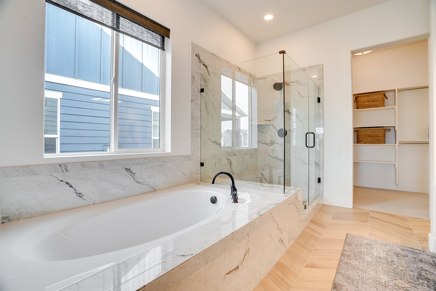 Bathroom with a bath, a marble finish shower, a spacious closet, and recessed lighting