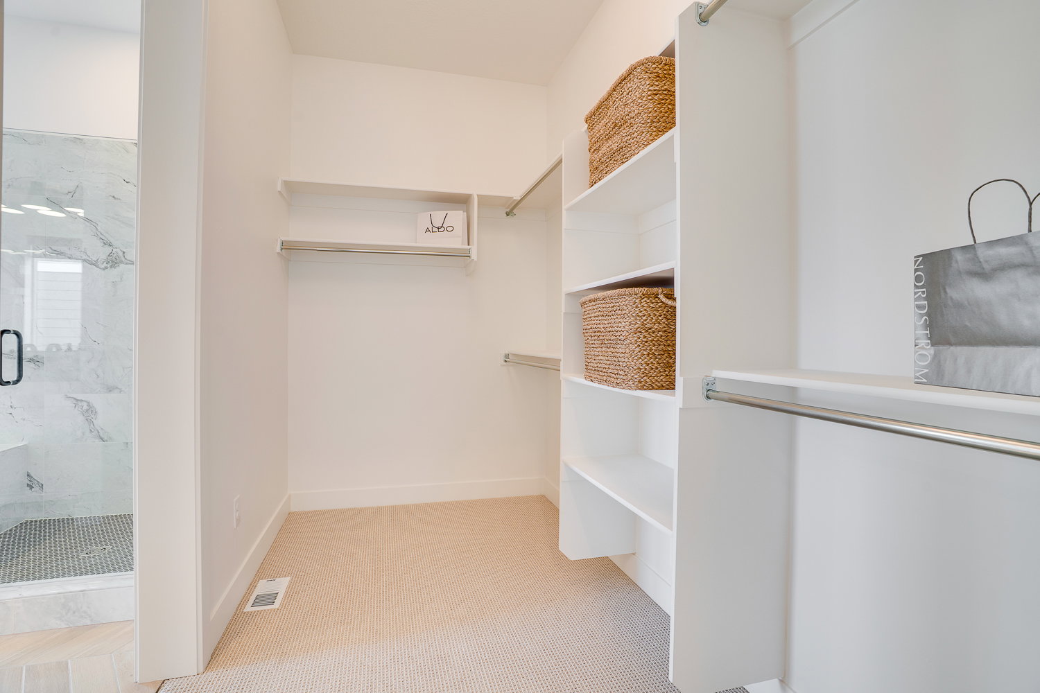 Spacious closet with light colored carpet