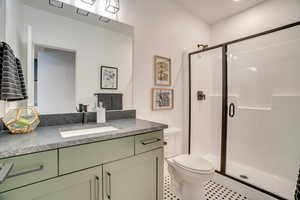Bathroom with a shower stall and vanity