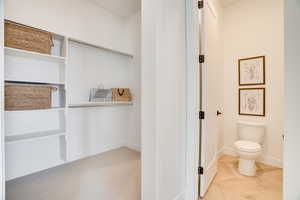Bathroom with toilet and baseboards