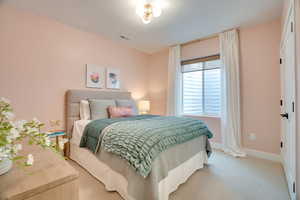 Bedroom with carpet floors and a textured ceiling
