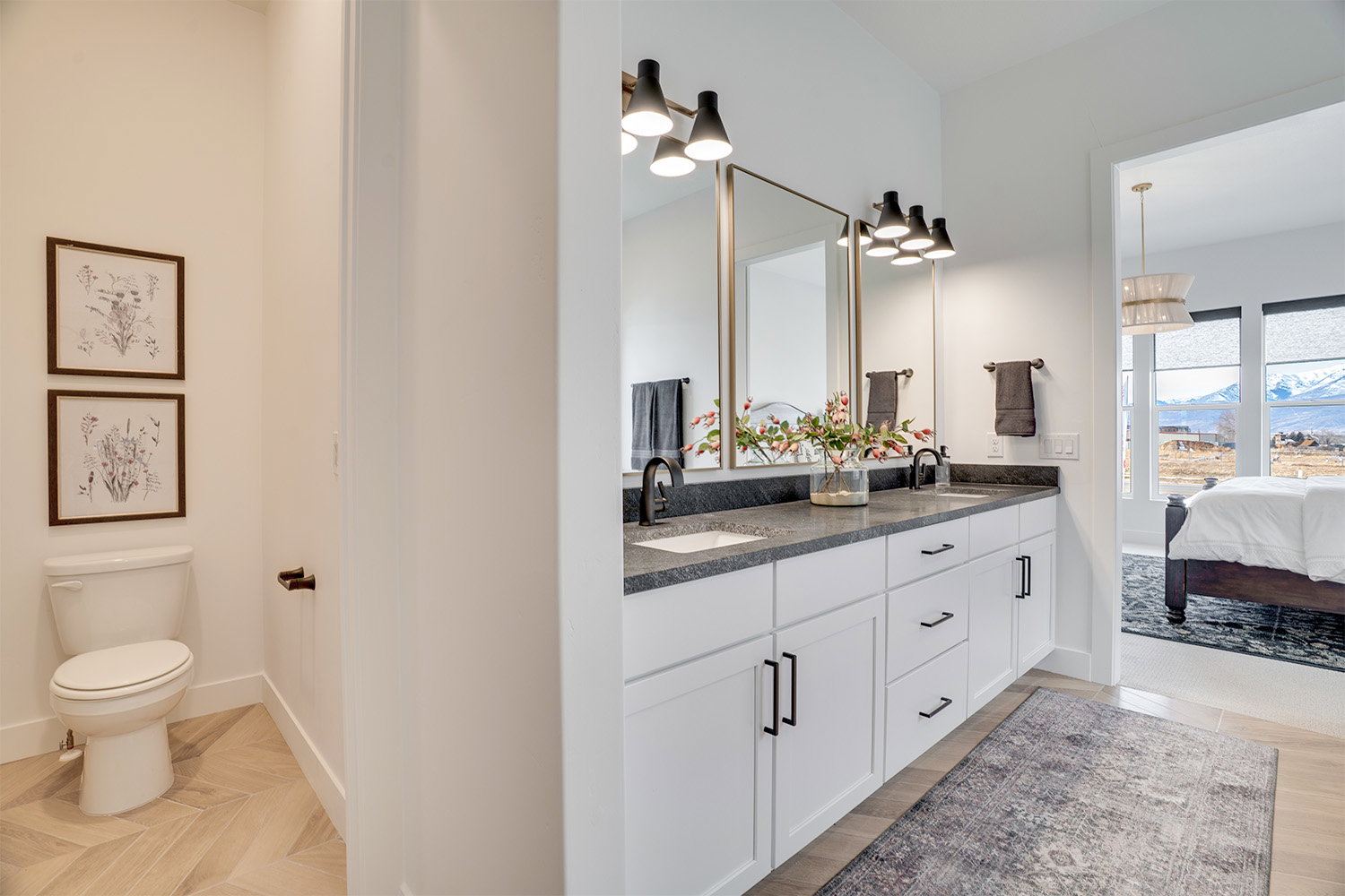 Ensuite bathroom featuring double vanity, parquet flooring, and a mountain view