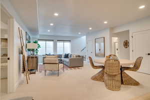 Dining area featuring light colored carpet, recessed lighting, and stairway