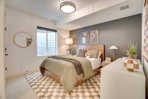 Bedroom featuring baseboards and light colored carpet
