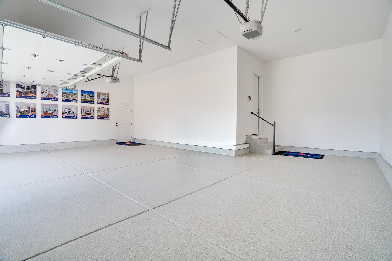Garage featuring a garage door opener and baseboards