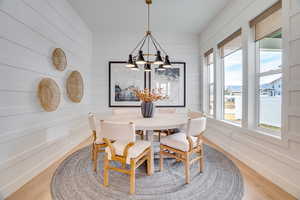 Dining area with a chandelier and light wood finished floors