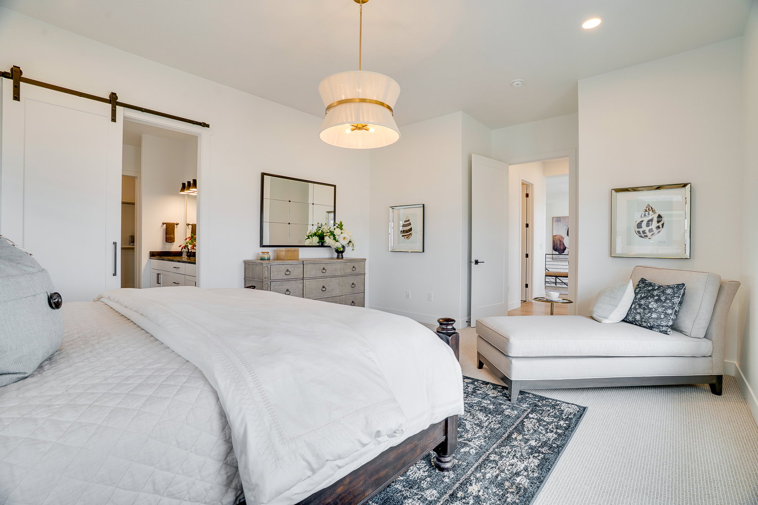 Bedroom featuring a barn door, carpet flooring, connected bathroom, and recessed lighting