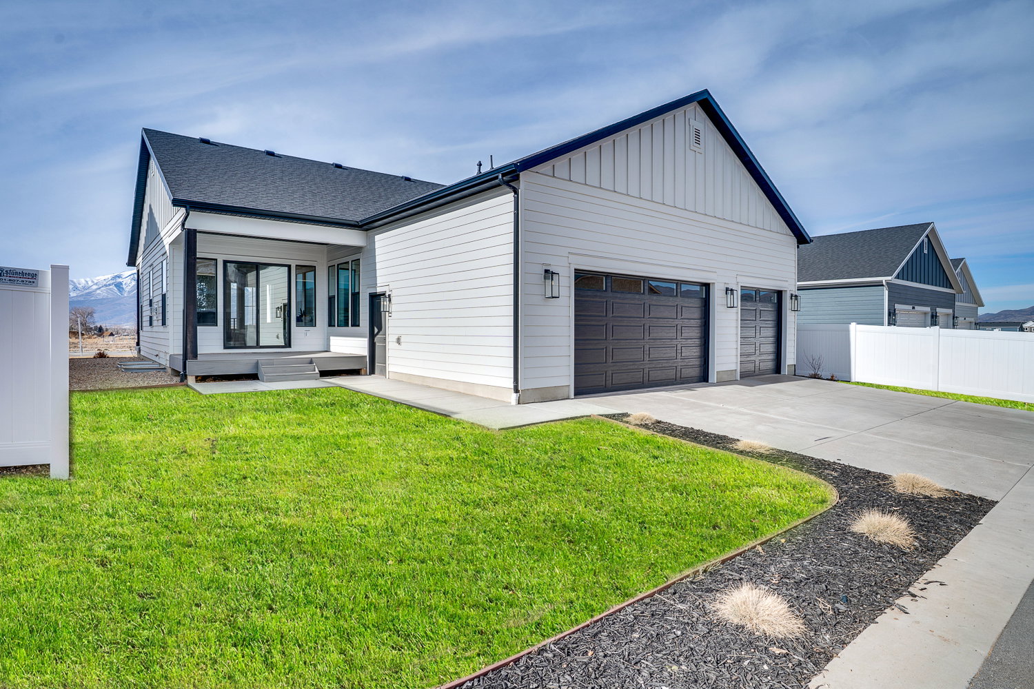 View of front of house featuring driveway, a mountain view, board and batten siding, a garage, and a shingled roof