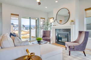 Living room featuring a tiled fireplace and recessed lighting