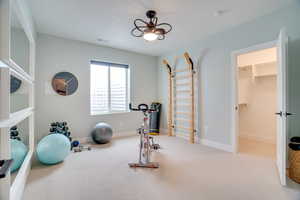 Workout room with carpet flooring and baseboards