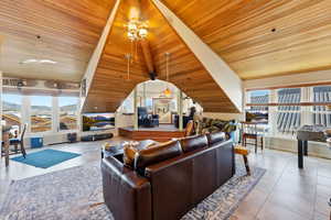 Living room with wood ceiling and light tile patterned floors