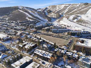 Snowy aerial view featuring a mountain view
