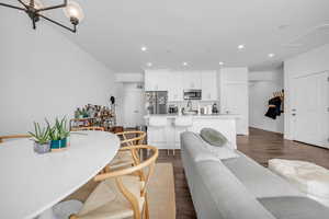 Living room with dark wood-type flooring and recessed lighting