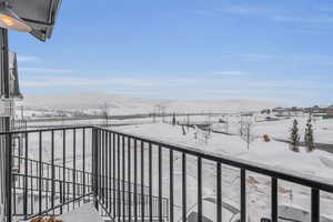 Snow covered back of property featuring a mountain view