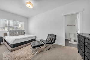Bedroom featuring baseboards and connected bathroom