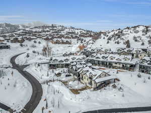 Snowy aerial view with a residential view and a mountain view